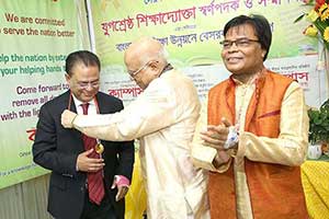 Former Minister Syed Abul Hossain receives `Jugosrestho Shikkhadoukta Sornopodok` Gold Medal from Finance Minister AMA Muhith; Next to him Dr. M Helal. (2018)